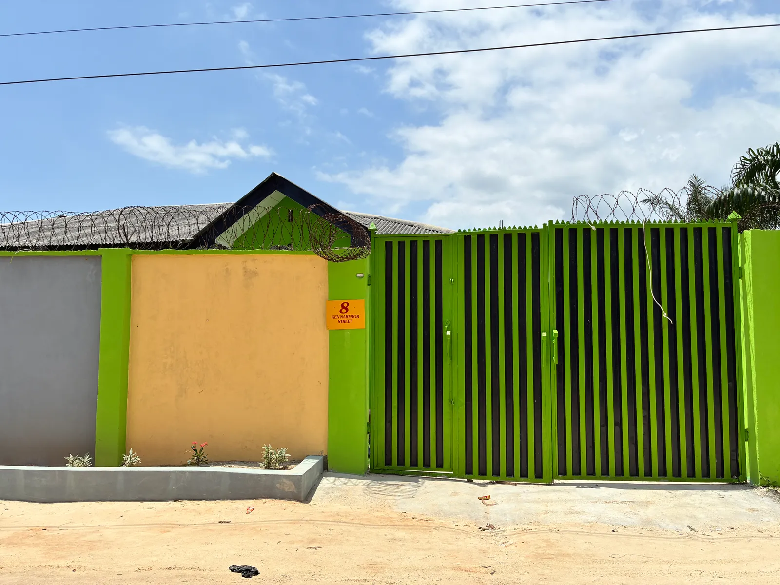 The green front gate of the school