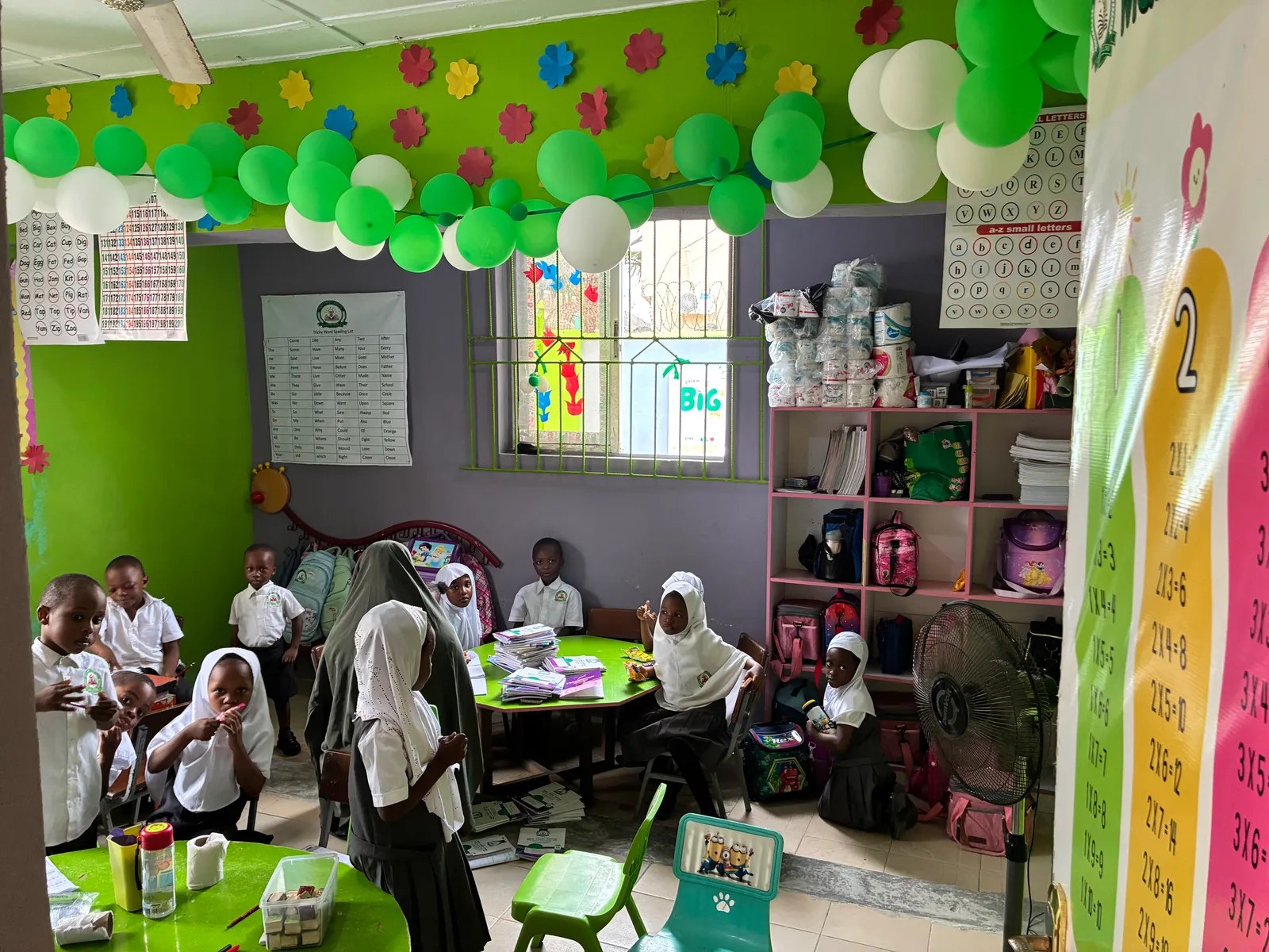 Nursery pupils and their teacher in a decorated classroom