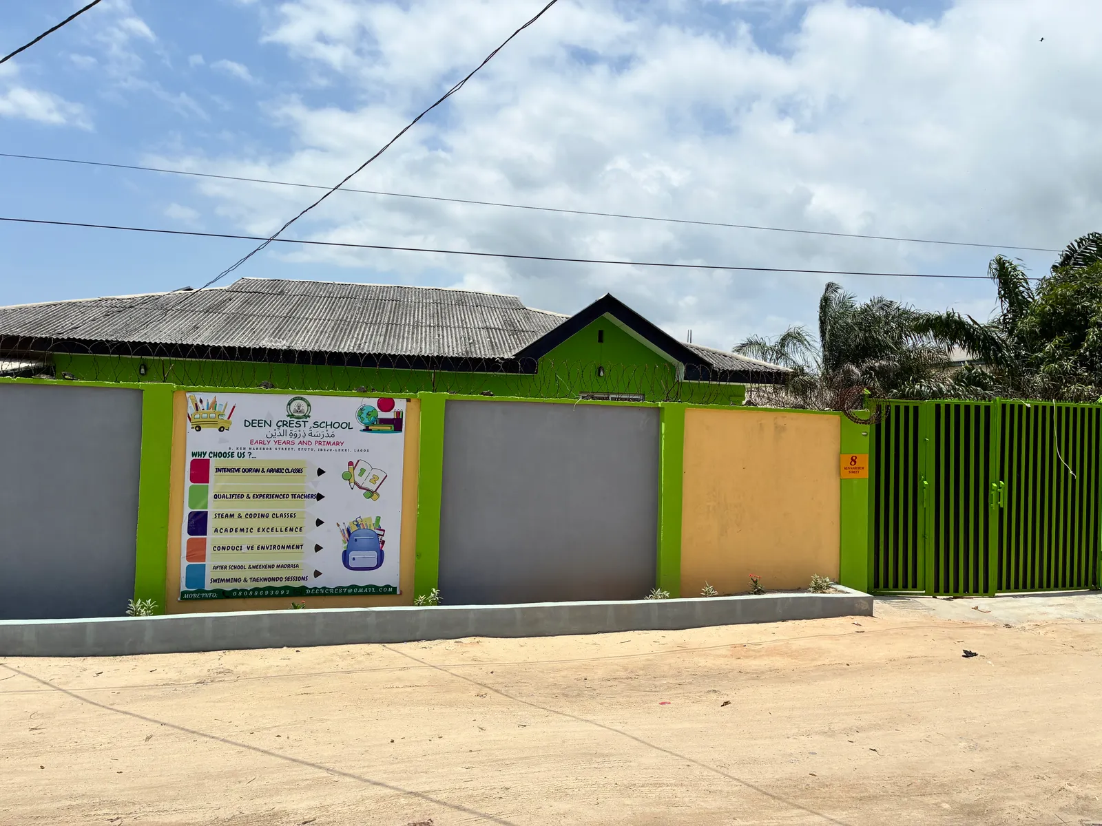 The school’s front wall and signboard on the street